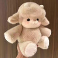 Plush toy with large ears held against a wooden background